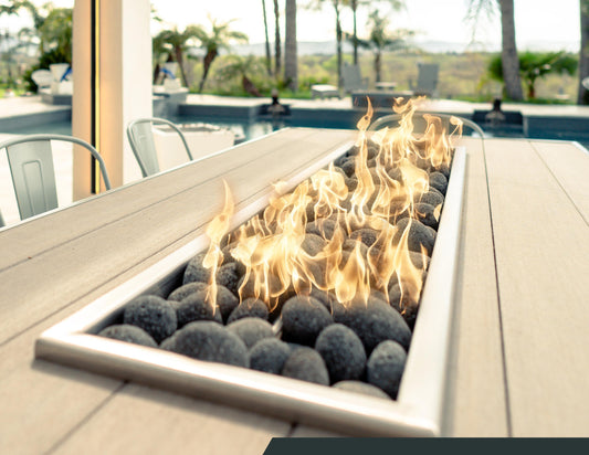 Close-up of linear burner and fire stones on the Alameda outdoor fire dining table