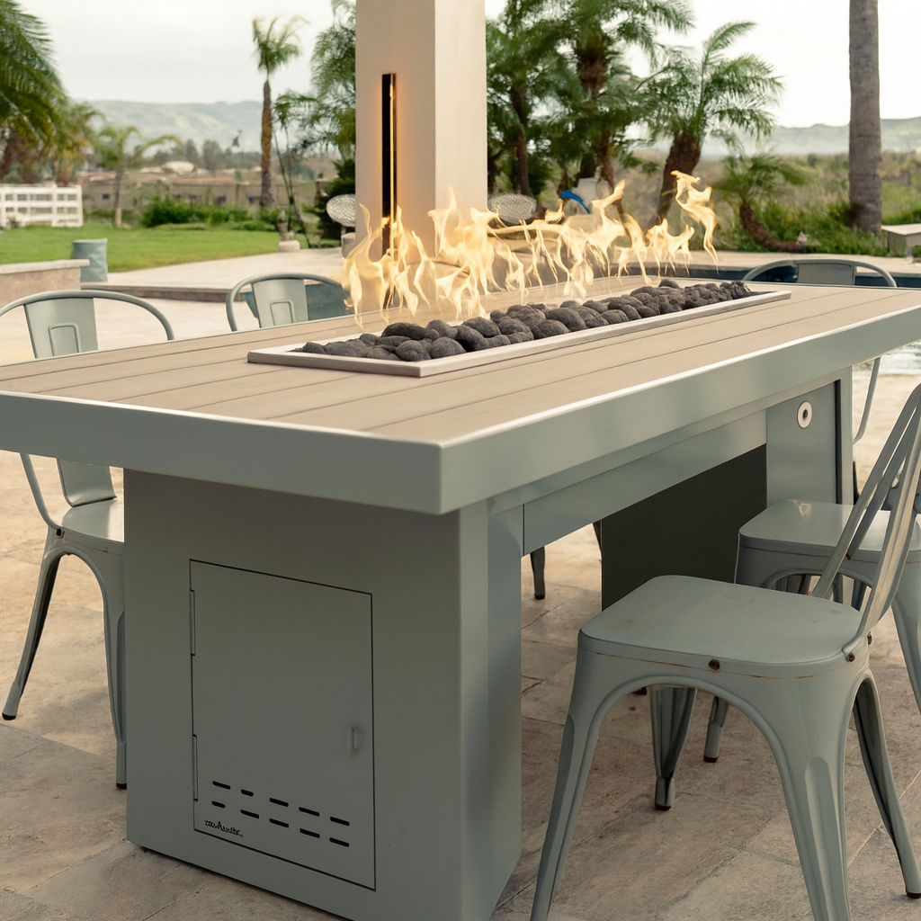 Alameda 78 inch modern outdoor fire table with linear flame, powder coat gray finish, styled with bar seating in a luxury setting